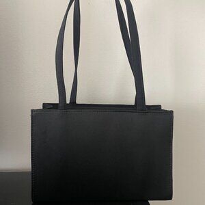 Structured black nylon shoulder bag with long straps.